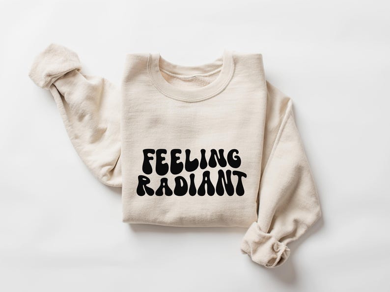 a sweater with the words feeling radiant printed on it