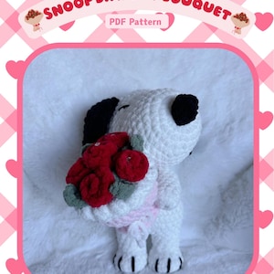 May include: Crochet pattern for a white Snoopy dog holding a bouquet of red roses. The pattern is titled "Snoop Dawg w/ Bouquet" and includes the text "PDF Pattern".