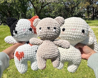 May include: A collection of handmade crochet stuffed animals, including a cat, bear, and bunny. The cat is white with black and orange accents, the bear is tan, and the bunny is white. The text "OK COZY PALS PDF Pattern" is at the top.