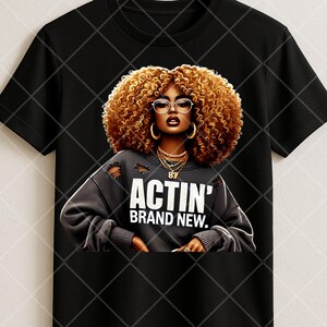 May include: Black t-shirt featuring a graphic of a woman with curly brown hair, glasses, and gold jewelry. The woman is wearing a gray sweatshirt with the text "ACTIN' BRAND NEW."