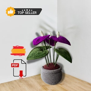 May include: Crochet pattern for a purple and green Anthurium plant in a grey pot. The pattern is available as a PDF download. The pattern is a top seller.