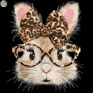 May include: Embroidered image of a bunny face wearing glasses and a bow. The bow and glasses frames have a leopard print pattern. The bunny's ears have pink inner ears, and the background is black.