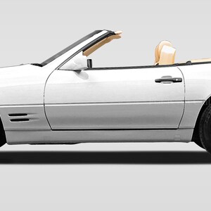 May include: A white convertible car with the top down. The car has a tan interior and is parked on a gray background.