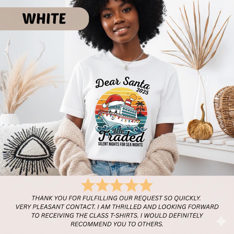 May include: White t-shirt with a colorful graphic featuring a ship wearing a Santa hat, the text "Dear Santa 2025", and "We Traded Silent Nights for Sea Nights". The shirt is worn by a person.
