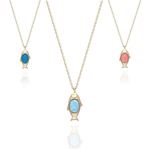 May include: Three gold necklaces with fish pendants. The fish have different colored stones: blue, opal, and pink.