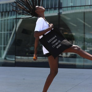 Black Tote Bag with the bold expression: ‘I move away from the human, it’s my animal side’”