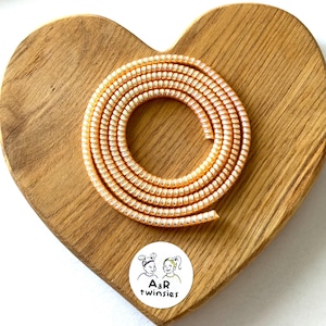 Plastic protective 30cm long cable (peach) for the protection of hearing implants and hearing aids