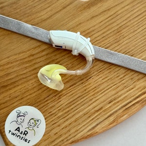 Grey non slip hearing aid headband with rubber loops