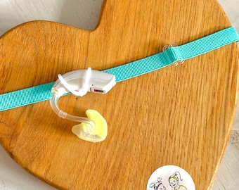 Turquoise Non-Slip Hearing Aid Headband with transparent Rubber Loops for Secure Fit and Comfort