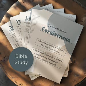 May include: A pile of Bible study guides on a wooden surface. The guides are titled "30 Day Bible Study on Forgiveness" and include text about scripture and cultivating a forgiving heart. A circular graphic reads "Bible Study".