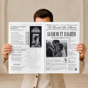 May include: A black and white wedding newspaper titled La Gazette Des Mariés featuring the names Manon et Damien. The layout includes a crossword puzzle, a trivia game, and a photograph of a couple, printed on white paper with black text.