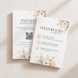 Peut inclure: Deux cartons blancs avec des motifs floraux et du texte. L'un dit "PARTAGEZ VOS PHOTOS AVEC NO" et comprend un code QR. L'autre dit "PHOTOBOOTH ET LIVRE D'OR" avec des instructions. Les cartes ont une esthétique douce et élégante.