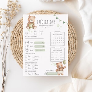 Peut inclure: Une carte de jeu de prédiction de bébé avec une illustration d'ours en peluche. La carte comprend des sections pour le sexe, les idées de noms, le poids, la taille, la couleur des yeux, la couleur des cheveux et à qui le bébé ressemblera. Le texte "PRÉDICTIONS POUR L'ARRIVÉE DU BÉBÉ" est en haut.