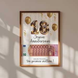 May include: A framed print with a brown wooden frame. The print features the number "18" in gold, the words "Joyeux Anniversaire", and a depiction of a million euros. Gold balloons and confetti complete the celebratory design.