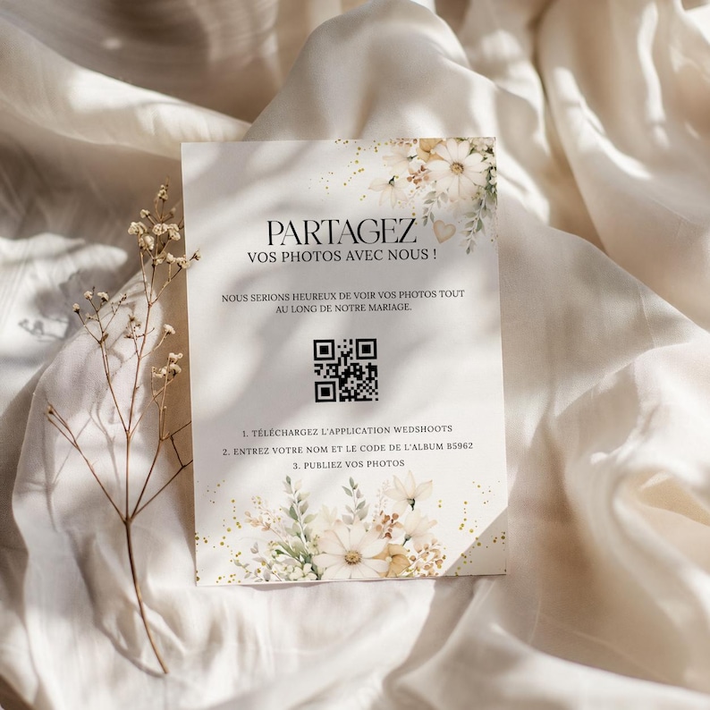 May include: A rectangular invitation card with floral accents and the text "PARTAGEZ VOS PHOTOS AVEC NOUS!" in a decorative font. The card includes a QR code and instructions for sharing photos at a wedding.