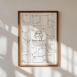 Peut inclure: Un cadre en bois brun clair contenant une impression avec une grille de post-it vierges et une illustration de chat faisant un geste obscène. Le texte en français dit "Bonne chance!" et d'autres mots en dessous.