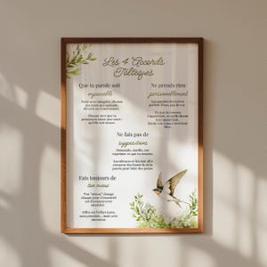 May include: A framed wall print featuring the text Les 4 Accords Tolteques in French, accompanied by four principles, green leaf illustrations, and a flying bird. The design is set against a white background within a dark brown wooden frame.