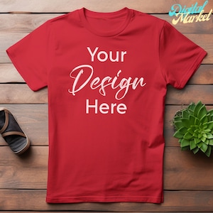 Puede incluir: Camiseta roja con el texto "Your Design Here" impreso en blanco en la parte delantera.