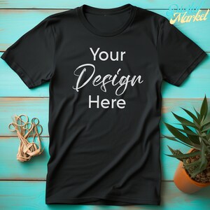 Puede incluir: Camiseta negra con el texto "Your Design Here" impreso en blanco en la parte delantera.