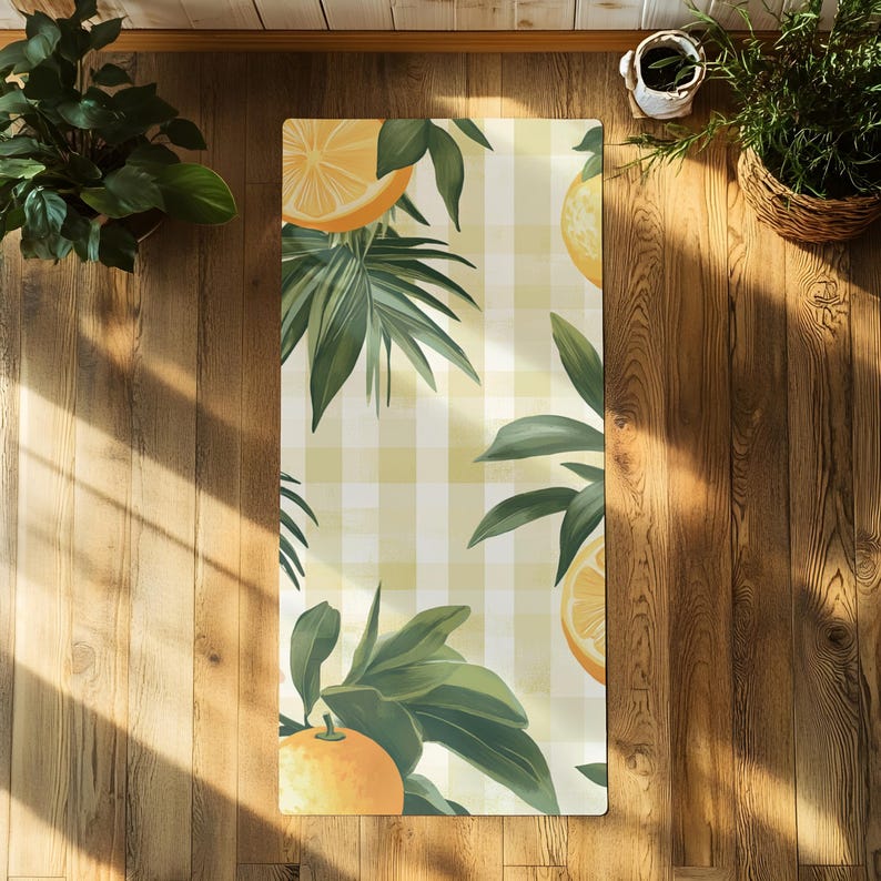May include: A yellow and white checkered yoga mat with a green leafy design and orange citrus fruit illustrations.
