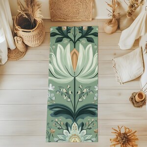 May include: A green yoga mat with a floral pattern featuring white flowers and green leaves. The pattern is symmetrical and has a vintage aesthetic.