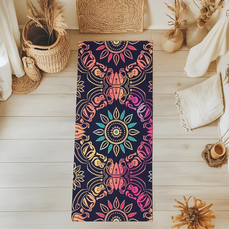 May include: A yoga mat with a colorful mandala design on a dark blue background. The mandala features intricate details and a gradient of pink, orange, yellow, and green.