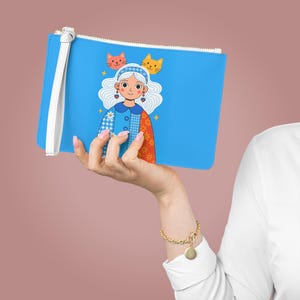 Whimsical Cartoon Girl Clutch Bag, Pouch, Kids Decor - Playful Cat Illustration, Floral Patchwork Jacket, Heart Earrings, Blue Background,