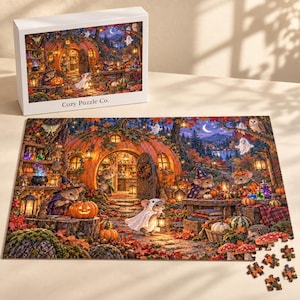 May include: A rectangular jigsaw puzzle featuring a whimsical autumn scene with mice dressed in costumes outside a pumpkin house. The illustration includes glowing lanterns, colorful fall foliage, and small ghosts. The box is labeled Cozy Puzzle Co.