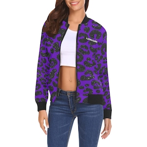 May include: A purple bomber jacket with a black leopard print and the text "ALIENMILKSHAKE" on the front.