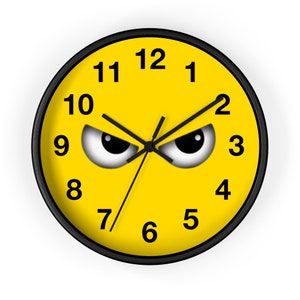 May include: A yellow clock face with black numbers and hands. The clock face has two large black eyes with white pupils and black eyebrows. The clock face is surrounded by a black frame.