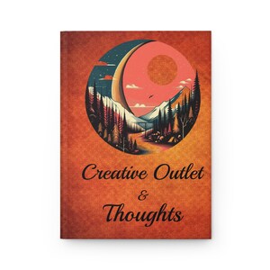 May include: A journal with an orange cover featuring a circular design of a mountain landscape with a crescent moon and sun. The text "Creative Outlet & Thoughts" is printed below the design.