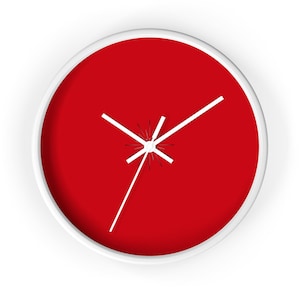 May include: A red clock with white hands and a white frame. The clock is set to 3:00.