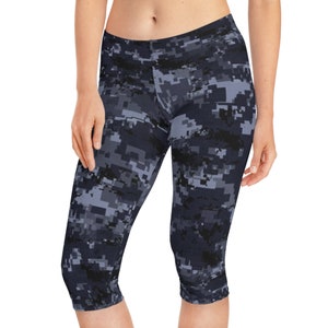 May include: Black and gray pixelated camouflage print capri leggings.