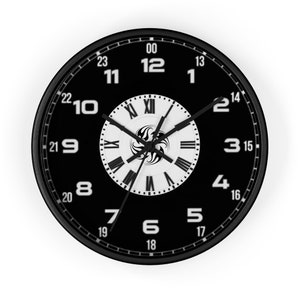 May include: A black and white clock with Roman numeral markings on the inner face and Arabic numerals on the outer face. The clock has a black background and white hands.