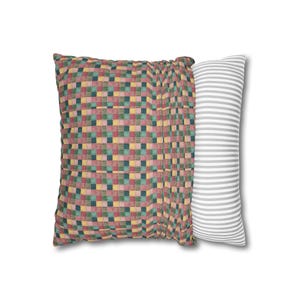 May include: A patchwork pillow with a red, green, yellow, and blue checkered pattern. The pillow is paired with a white pillow with gray stripes.