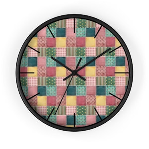 May include: A round wall clock with a black frame and a patchwork quilt design. The quilt is made up of squares in shades of red, yellow, green, and blue.
