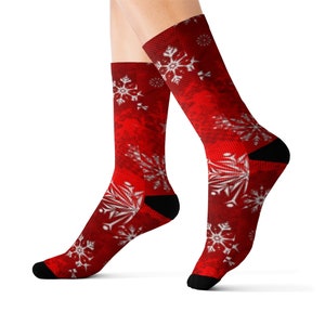 May include: Red socks with a white snowflake pattern. The socks are made of a soft, comfortable material and are perfect for the holiday season.