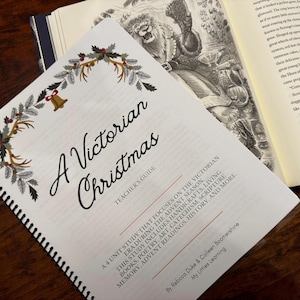 May include: A spiral-bound teacher's guide titled "A Victorian Christmas" with a decorative border of greenery and a bell. The guide is open next to a book with illustrations. The guide focuses on the Victorian era during the Advent season.