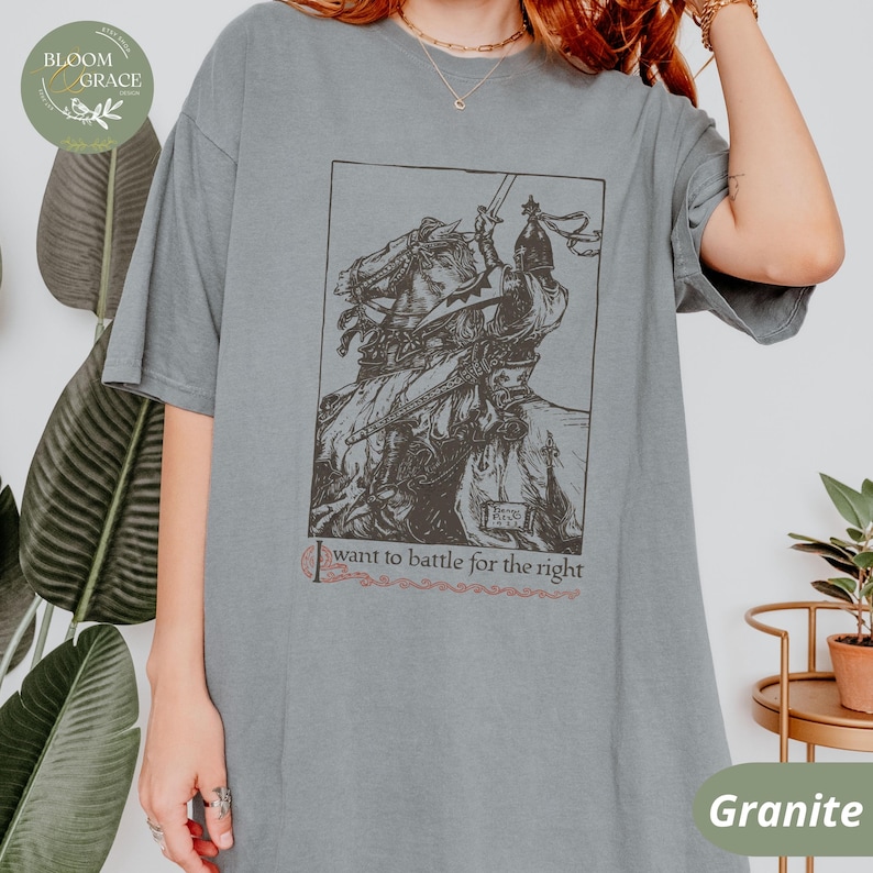May include: A gray t-shirt with a black and white illustration of a knight on horseback. The text "I want to battle for the right" is printed below the illustration.
