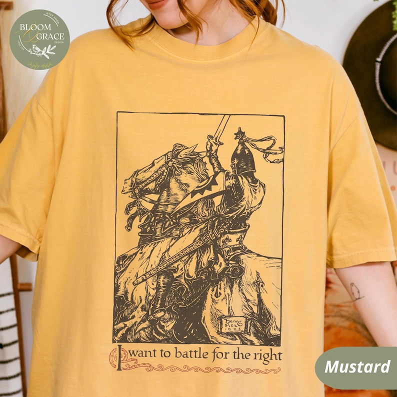 May include: A mustard yellow t-shirt with a vintage illustration of a knight on horseback. The text "I want to battle for the right" is printed below the illustration.