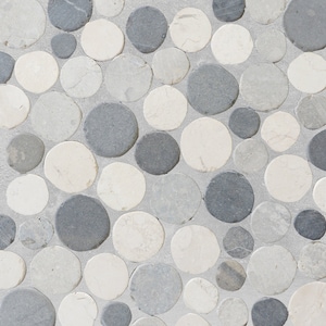 May include: A close-up of a mosaic tile pattern made of round, smooth stones in shades of gray and white. The stones are arranged in a random pattern, creating a textured and visually appealing surface.
