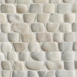 May include: A seamless pattern of light beige, rounded stones arranged in a brick-like pattern. The stones have a smooth, polished appearance, with subtle variations in color and texture, creating a natural, organic aesthetic. The background is a light beige color.