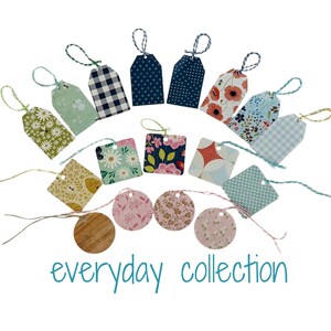 May include: A collection of 18 gift tags featuring a variety of patterns and designs. The tags are made from paper and have twine strings. The tags include floral, geometric, and polka dot patterns in shades of blue, green, pink, and yellow. The text "everyday collection" is printed at the bottom of the image.