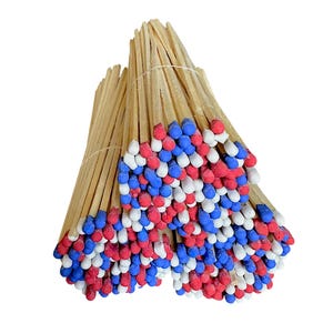 May include: Bundles of wooden matches with red, white, and blue tips, tied together with a thin string. The matchsticks are a natural wood color, creating a patriotic color scheme.