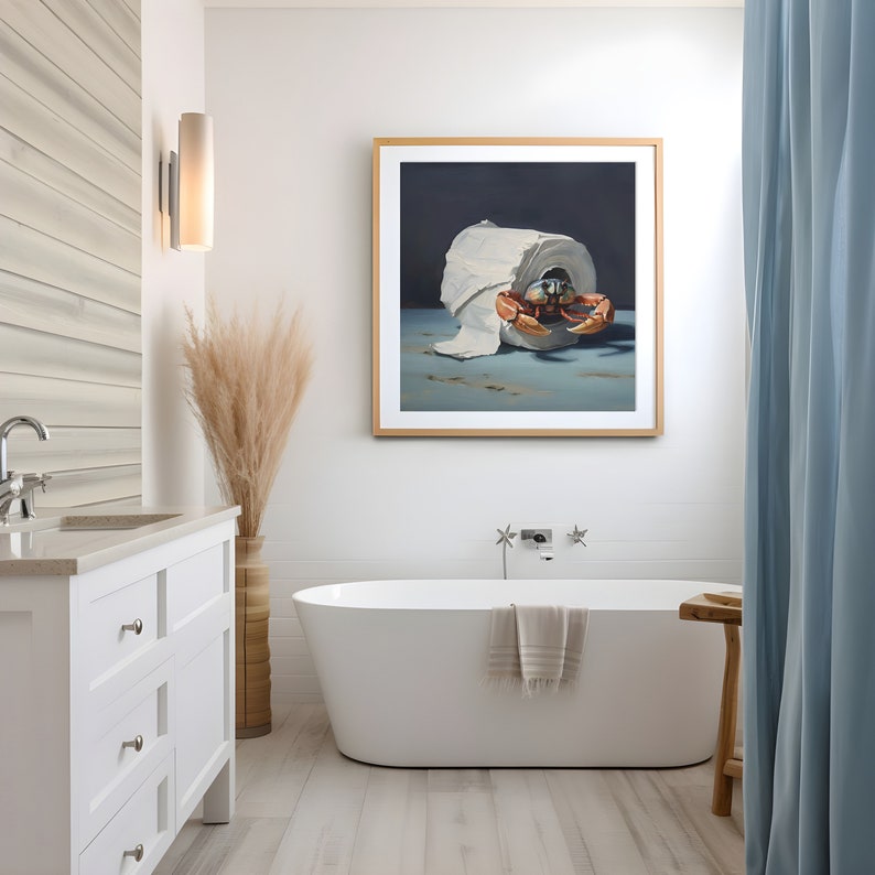 A coastal themed bathroom with a painting on the wall. The painting is of a crab crawling out of a roll of toilet paper against a dark background.