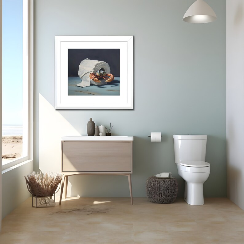 A coastal-themed bathroom with a painting on the wall. The painting is of a crab crawling out of a roll of toilet paper against a dark background.