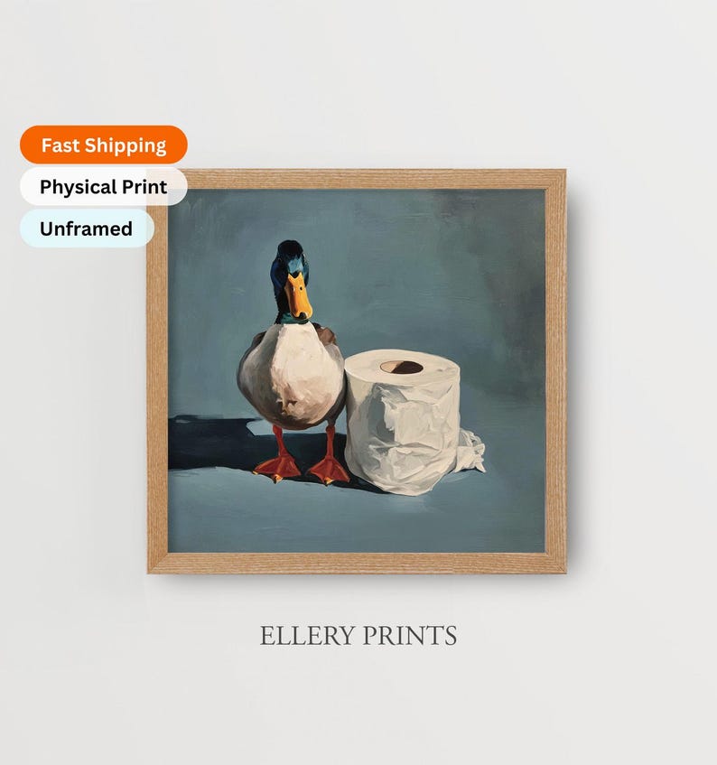 May include: A framed print featuring a duck and a roll of toilet paper. The duck has a blue and black head, a yellow beak, and red feet. The print is labeled "Ellery Prints".