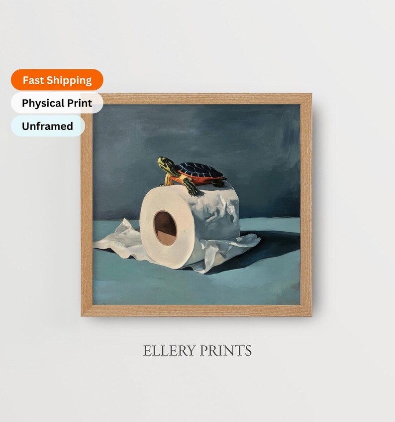 May include: A framed print featuring a turtle atop a roll of toilet paper. The artwork has a blue and green color palette. The text "ELLERY PRINTS" is at the bottom of the frame.