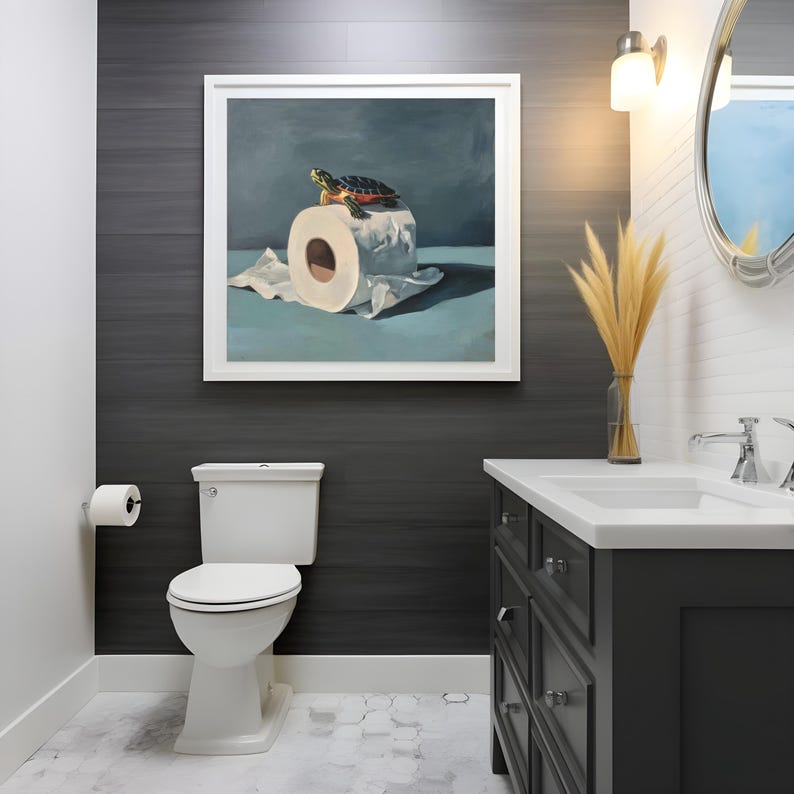 May include: A bathroom scene featuring a white toilet, a dark gray vanity, and a framed painting. The painting depicts a turtle on a roll of toilet paper. The walls are dark gray, and the floor is tiled.
