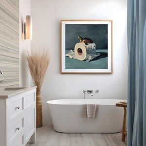May include: A framed artwork depicts a turtle atop a roll of toilet paper. The turtle has a green head and a patterned shell. The artwork is in a bathroom setting, with a white bathtub, a wooden stool, and a blue curtain.